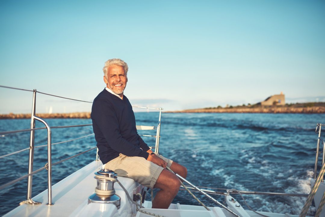 mature man enjoying a day sailing on the ocean